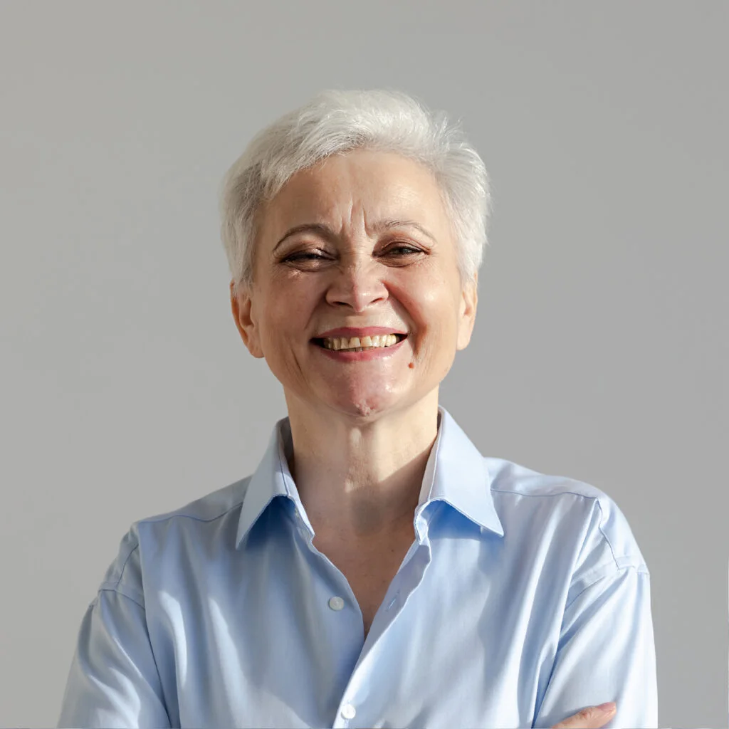 A woman with short grey hair smiling